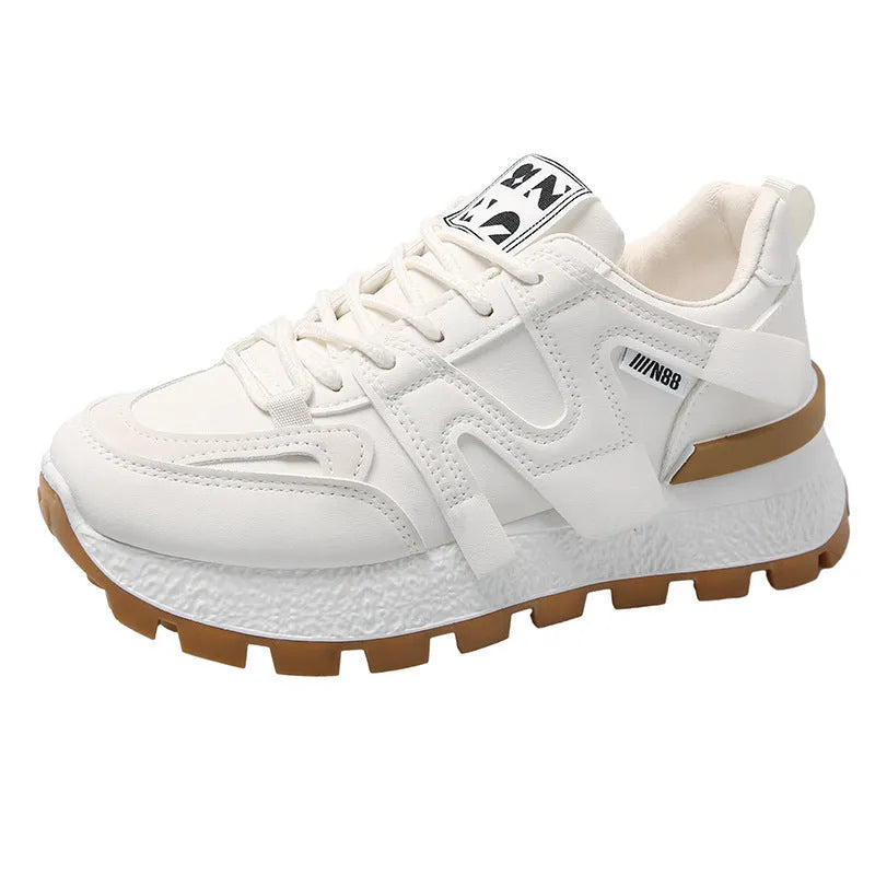 A pair of solid-colour low-top lace-up sneakers with a round toe and flat rubber sole.