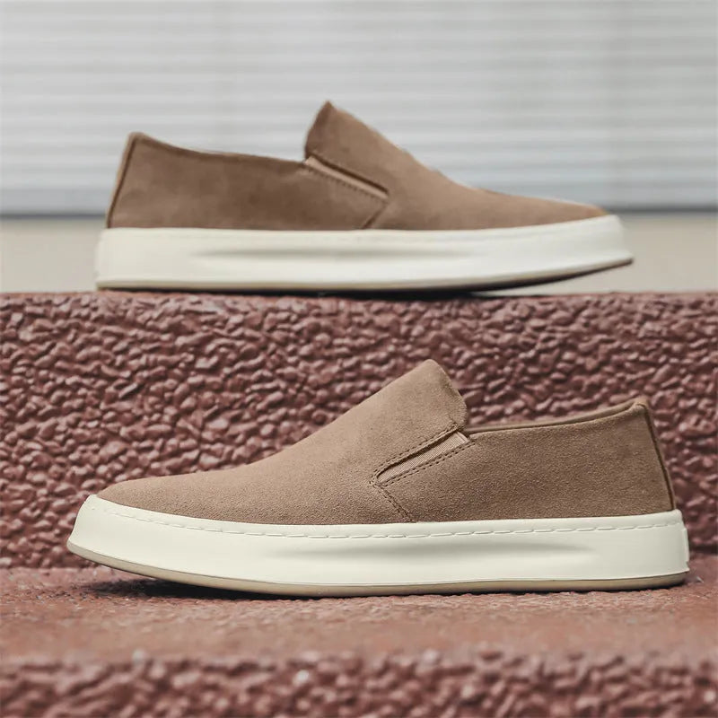 Men's grey slip-on casual shoes with round toe design and visible stitching details