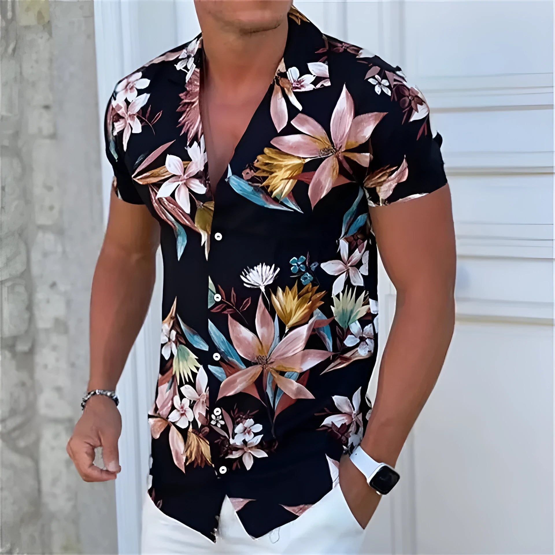 Man wearing a loose-fit short sleeve shirt with a colourful digital flower print pattern.