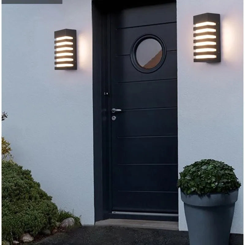 Modern minimalist aluminium outdoor wall lamp mounted on an exterior wall.