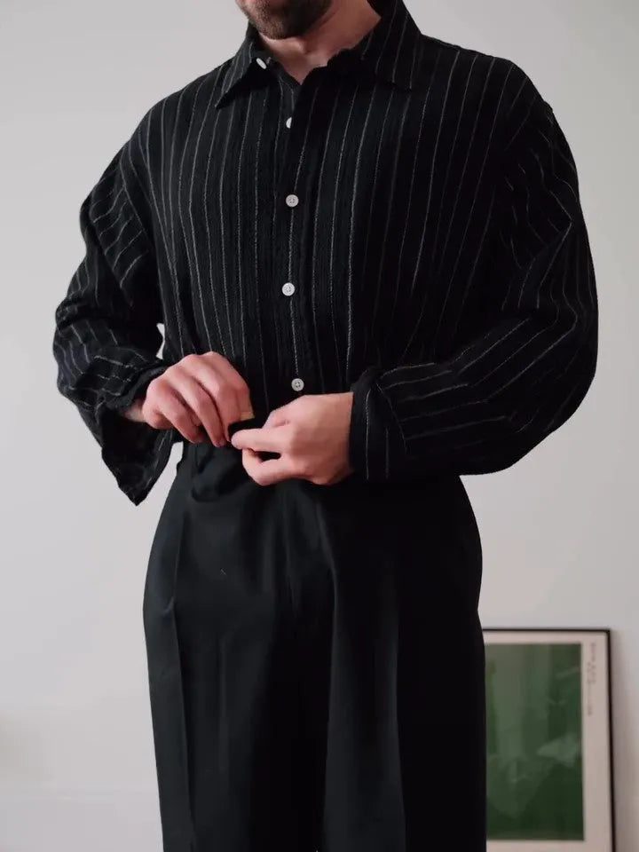 Black pinstripe button-down long-sleeve shirt laid flat, showing regular fit and striped pattern.