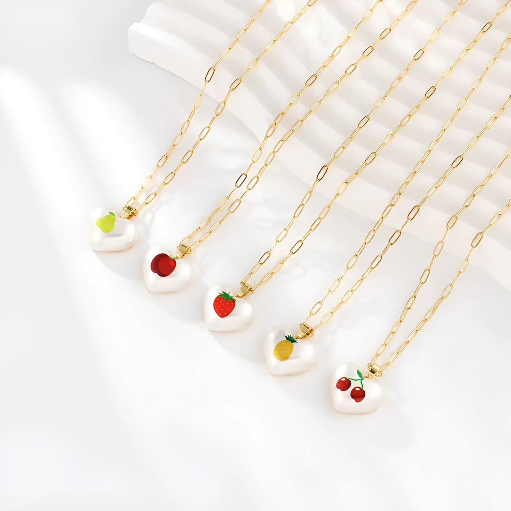 Geometric fruit charm necklace with an adjustable chain, shown in strawberry, pineapple, apple, pear, and cherry colour variants.