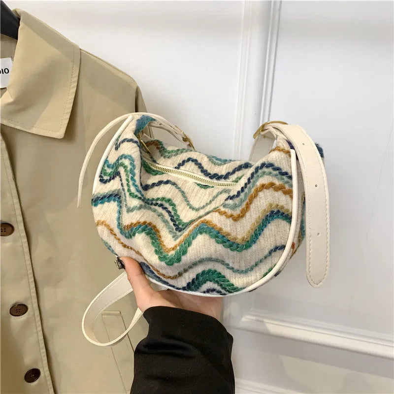 Straw woven crossbody bag showing woven texture and interior phone compartment