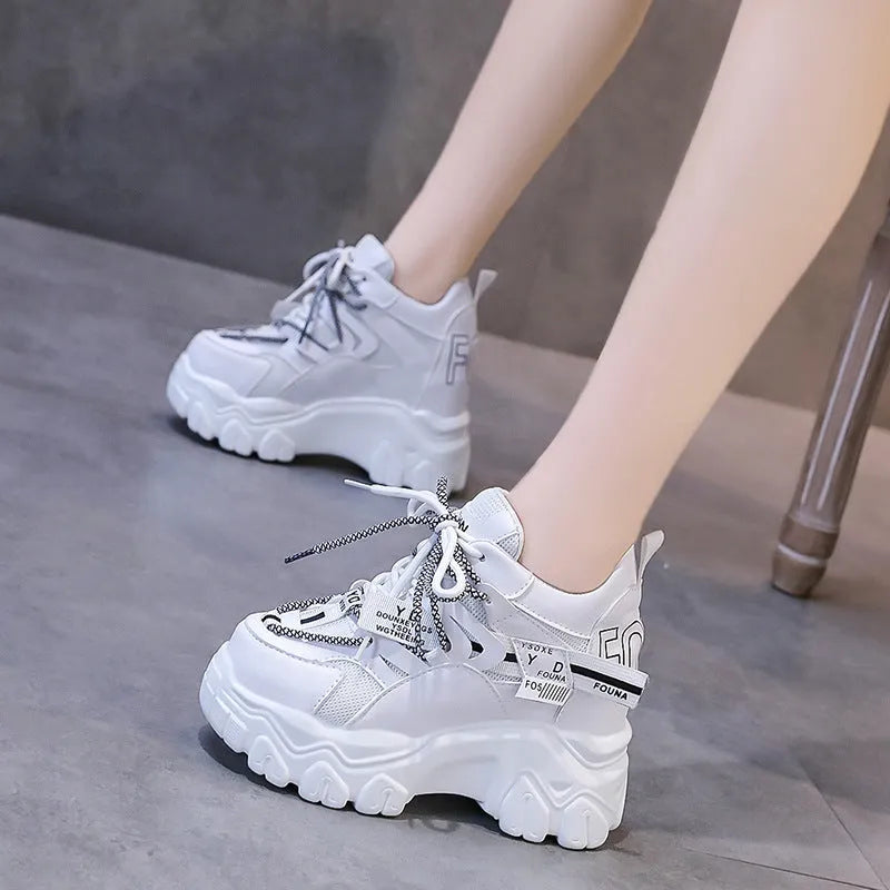 Women's white breathable mesh platform sports shoes with cross strap and rubber sole.