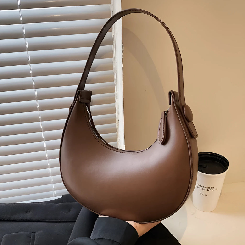 Women's retro-style PU shoulder bag in a dumpling shape, shown in one of four colours: black, cream yellow, brown, or white.
