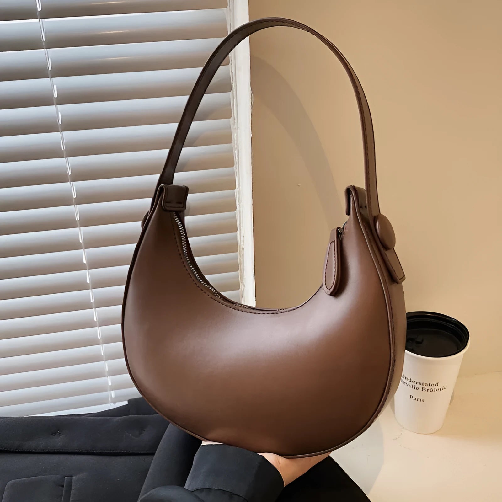 Women's retro-style PU shoulder bag in a dumpling shape, shown in one of four colours: black, cream yellow, brown, or white.