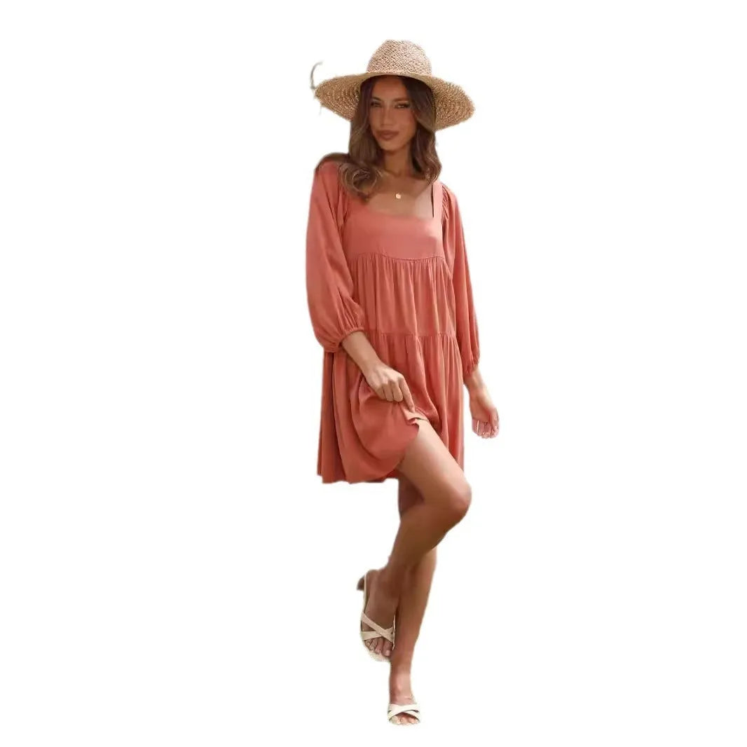 A child's orange puff sleeve dress with a square collar and backless design, featuring an A-line silhouette.