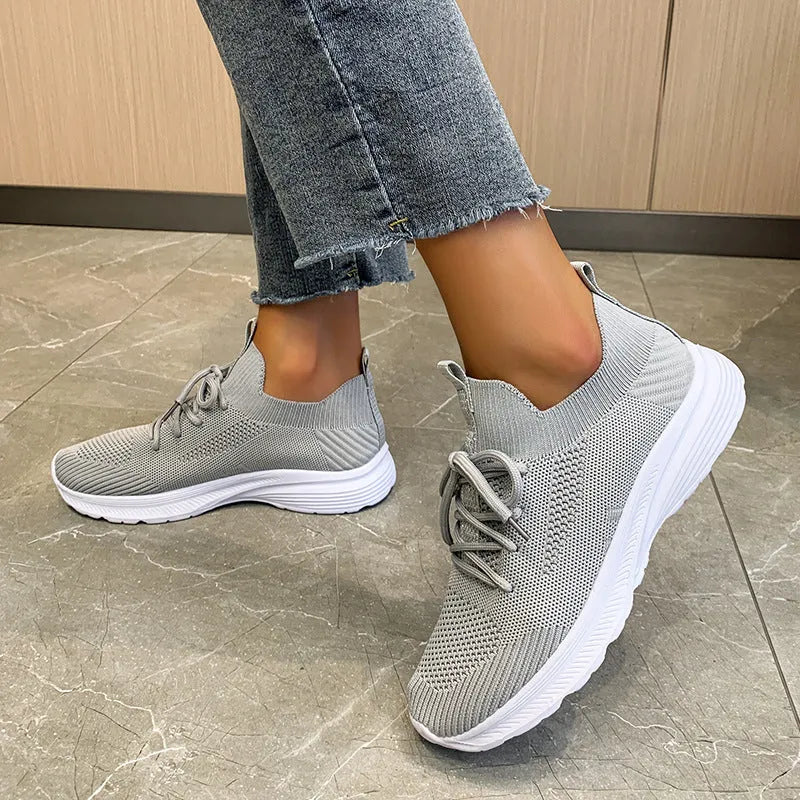 Women's Flyknit running shoes in Creamy White with mesh lining and rubber sole