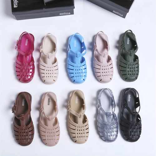 Black Roman-style sandals with buckle fastening and hollow-out design on low-top PVC upper