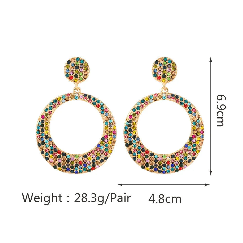 Large round pendant earrings with cartoon design and diamante accents on alloy metal