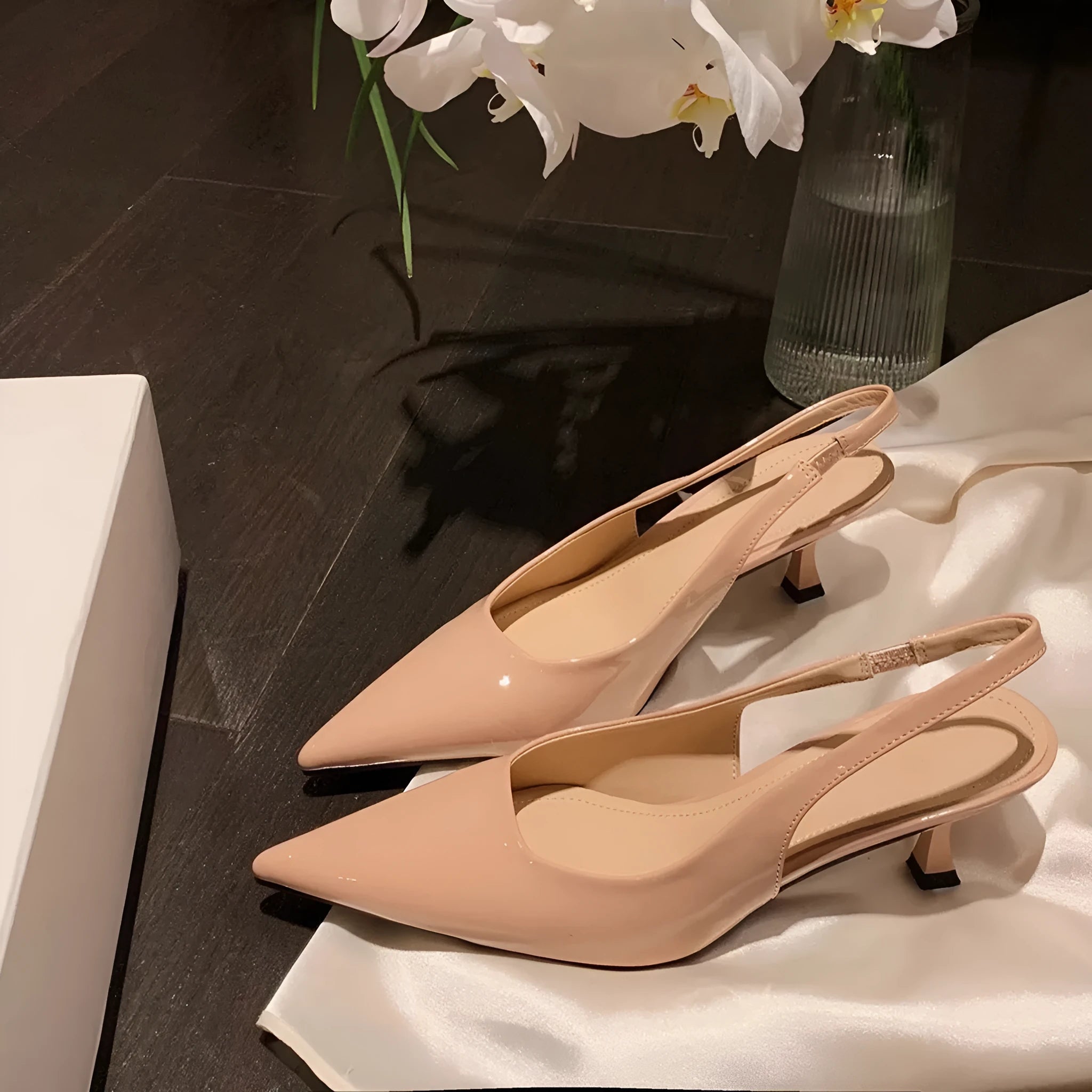 Women's pointed toe stiletto high heel pumps in black and nude with microfiber upper