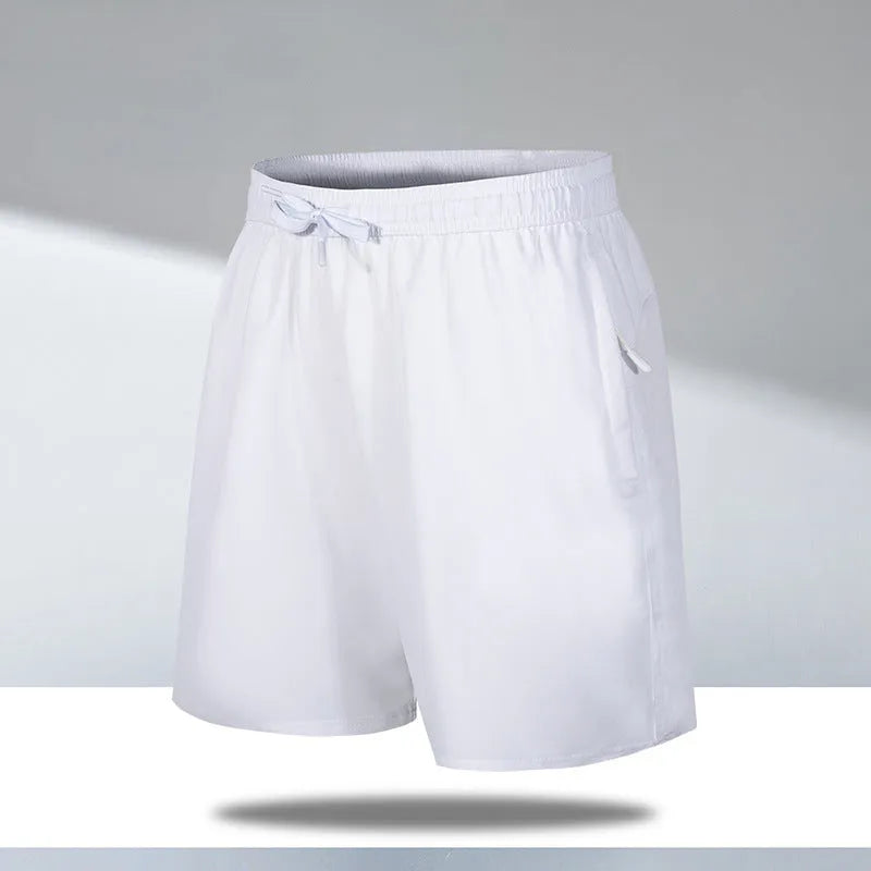 Man wearing loose-fit black quick-drying polyester beach shorts with a micro-elastic waistband.