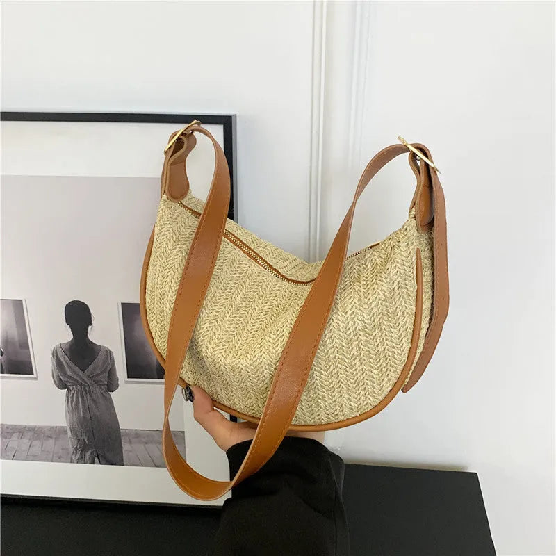 Straw woven crossbody bag showing woven texture and interior phone compartment