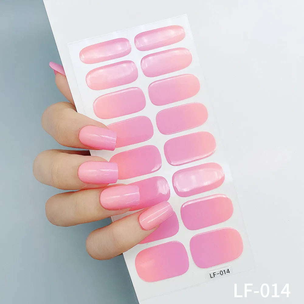 Set of 16 solid colour full nail art stickers showing patterns like cross, rose, tulip, and cartoon designs.