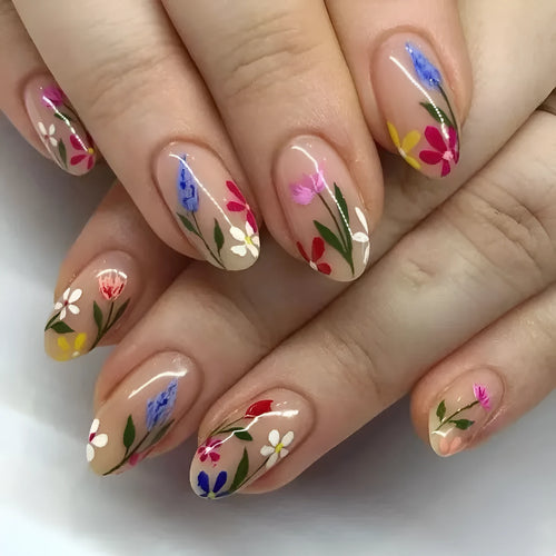 Almond-shaped false nails with detailed 3D pink rose and tulip floral designs on a solid colour base.