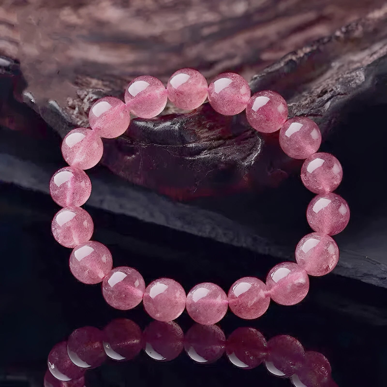 Women's strawberry quartz bracelet with polished beads in 6mm, 8mm, or 10mm sizes