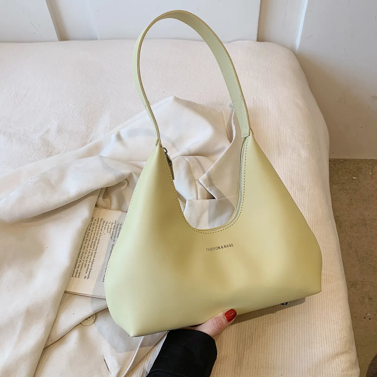 Retro style cream yellow PU shoulder handbag with single strap, sandwich pocket, and stitching detail.