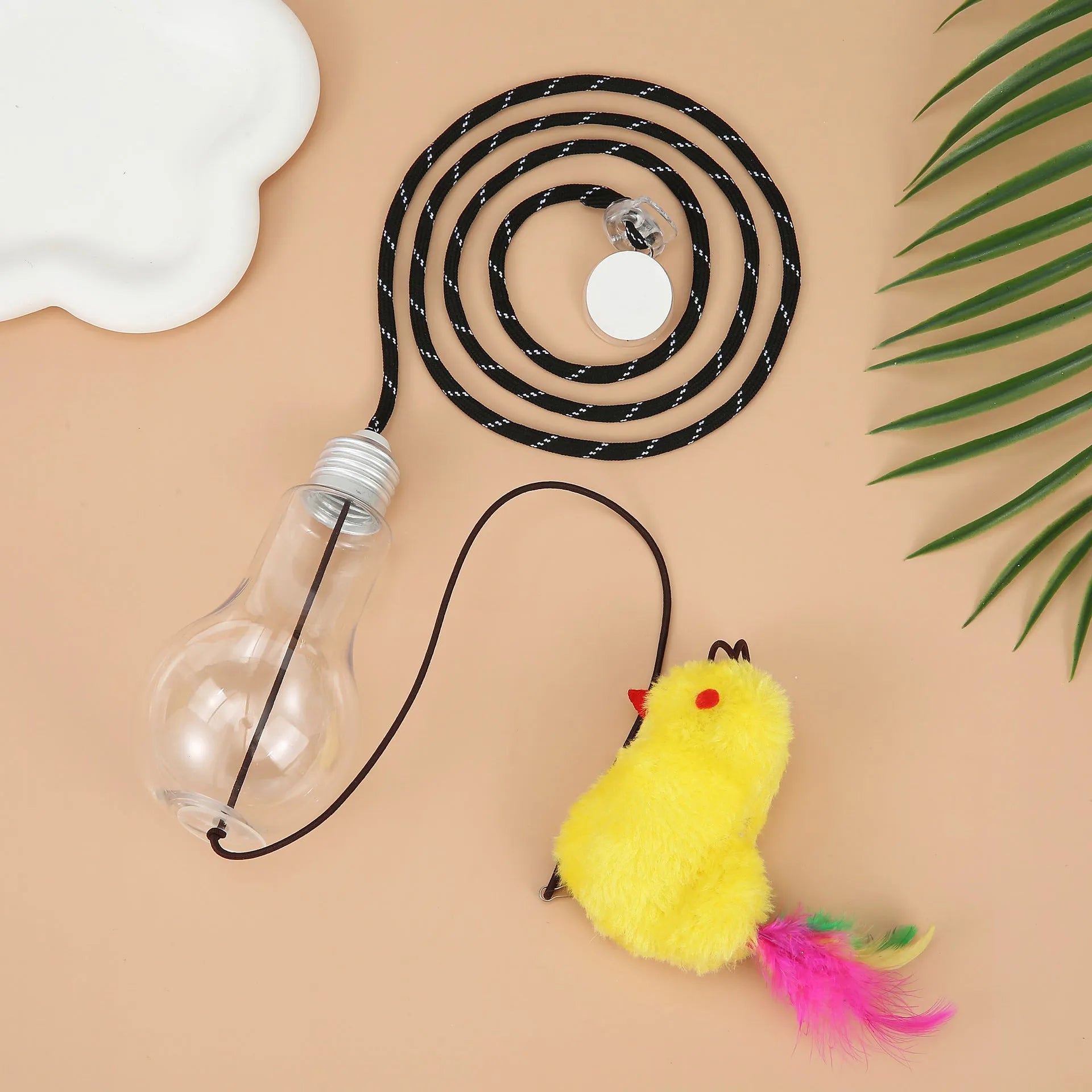 Interactive cat toy hanging from door frame with dangling mouse and chicken toys on elastic rope