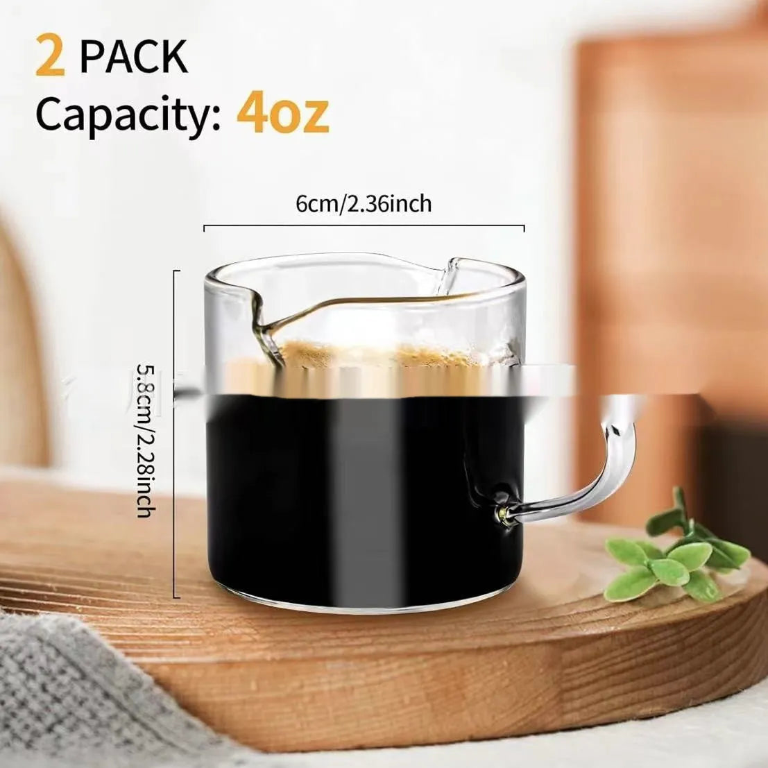 Two white transparent double mouth coffee glasses on a table.