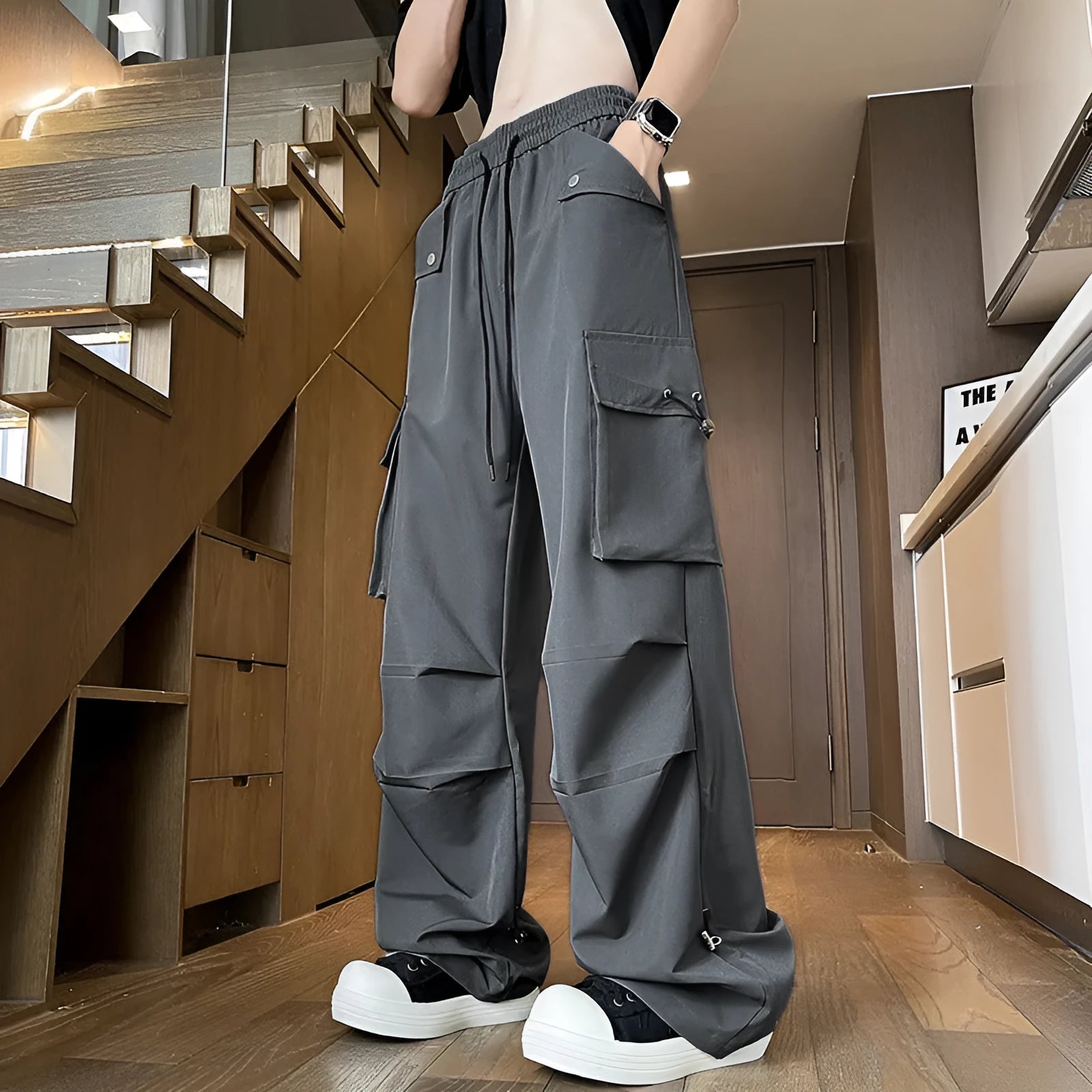 Black waterproof plus size loose fit straight-leg trousers with a drawstring waist.