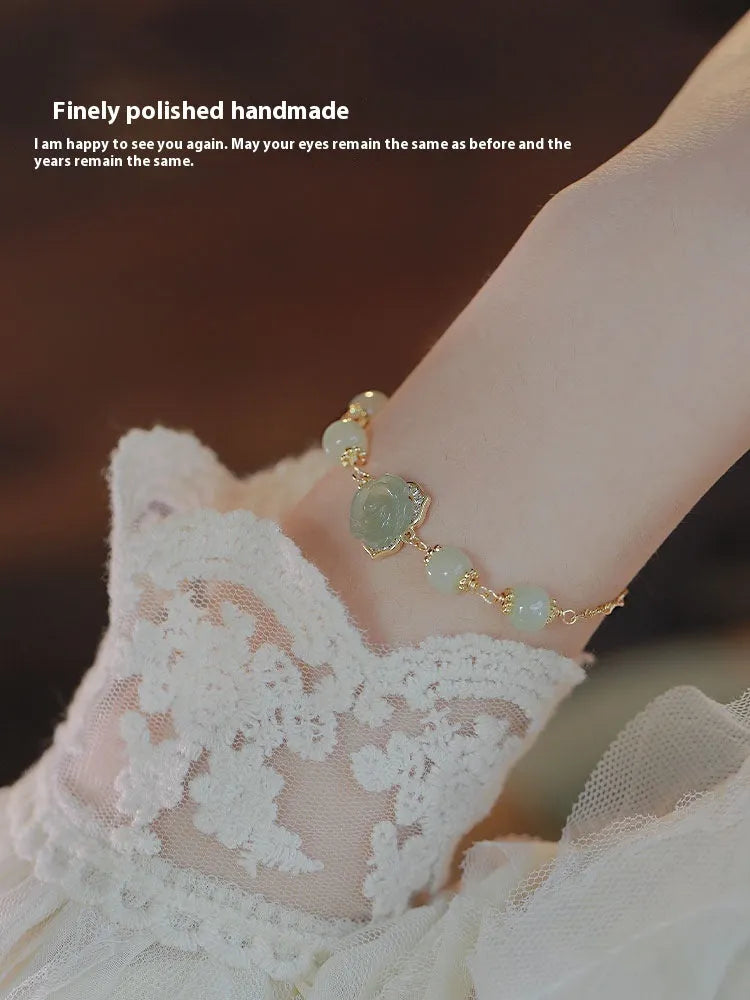 Handcrafted women's bracelet with Hetian Jade rose flower design and 14K gold gilded accents
