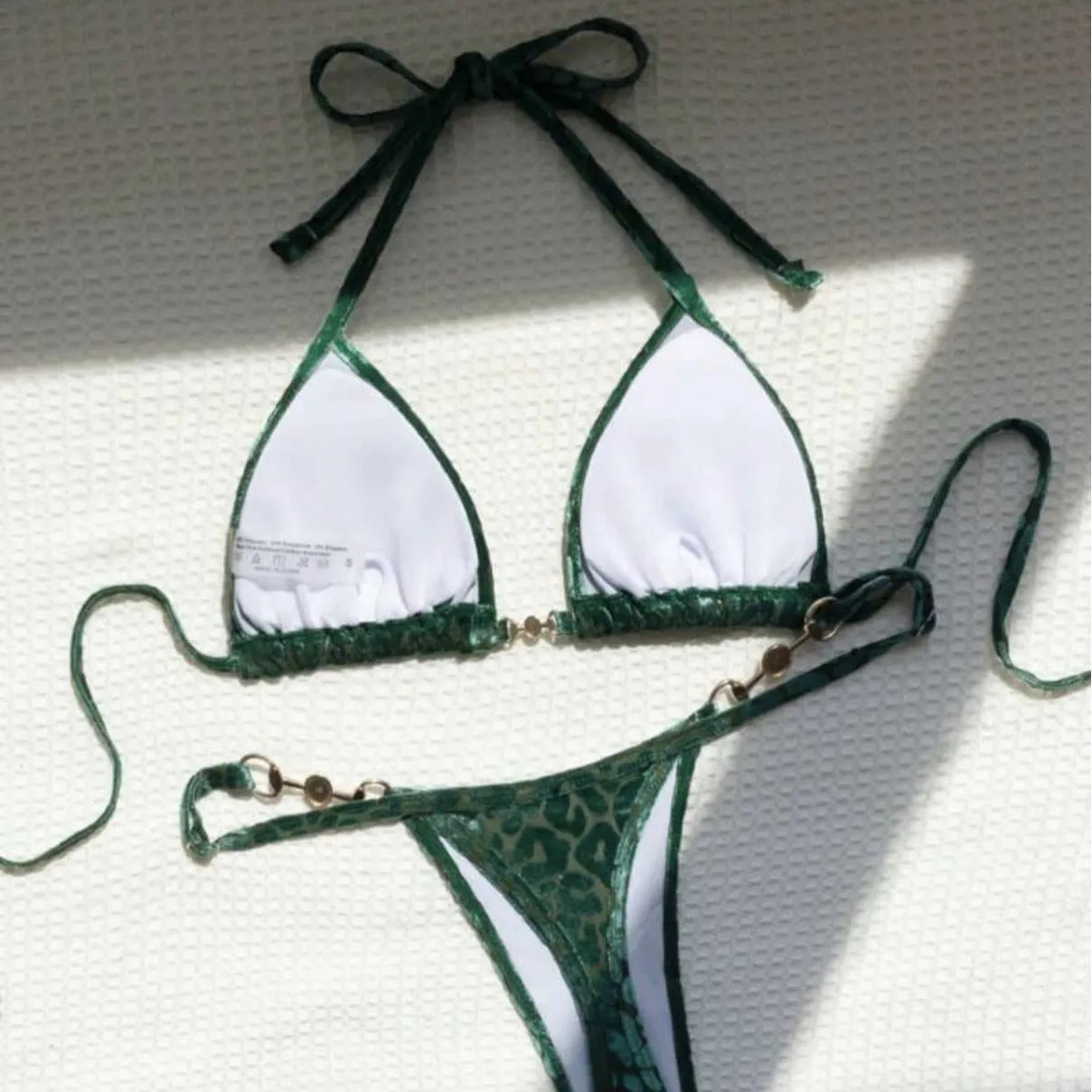 Women's blue leopard print T-shaped bikini swimsuit made from polyester and spandex fabric.