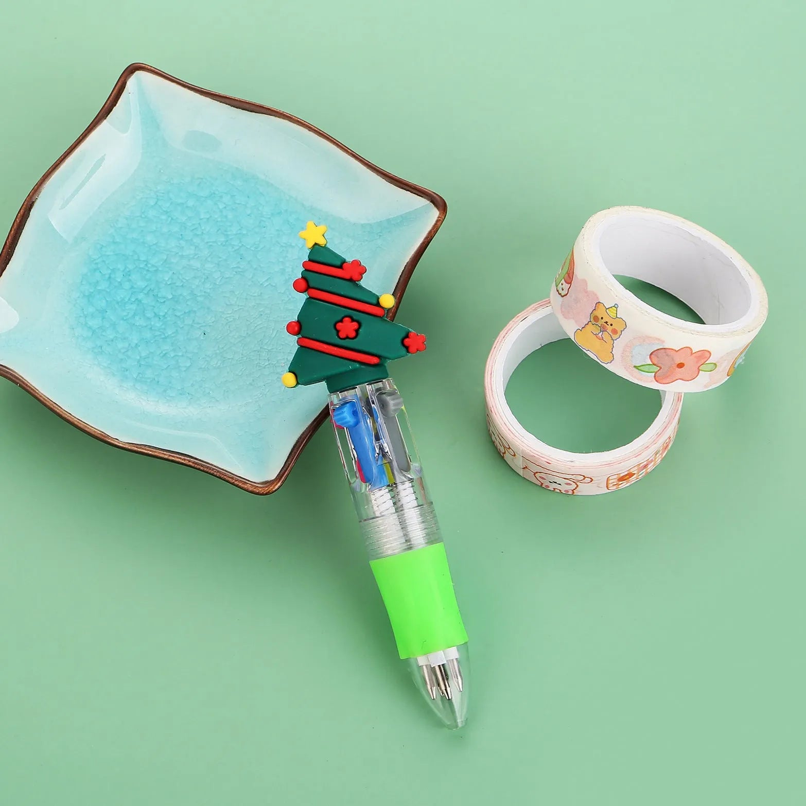 Compact 11cm Christmas-themed press-action ballpoint pen with festive designs.