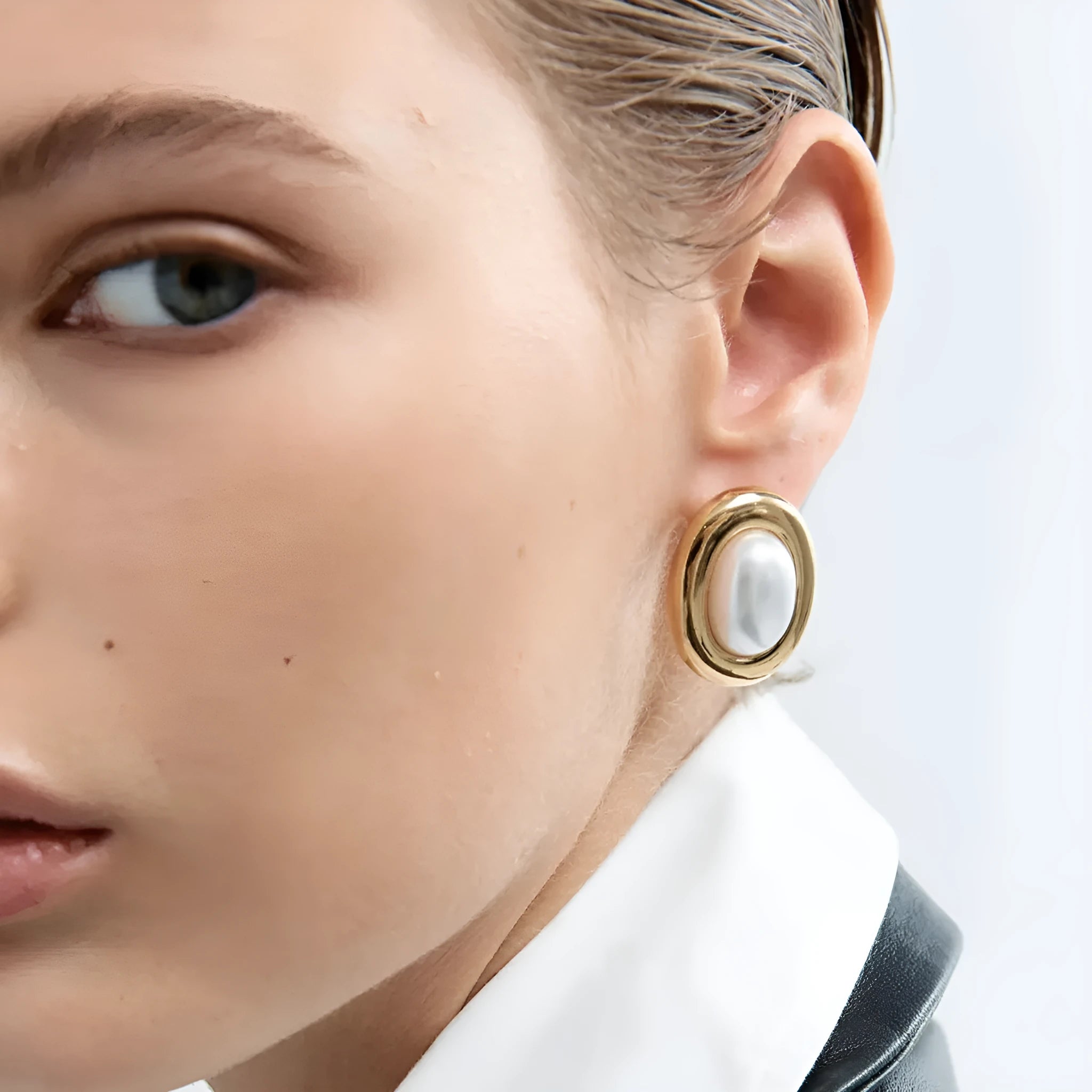 A pair of stainless steel vintage pearl stud earrings for women with an electroplated finish.