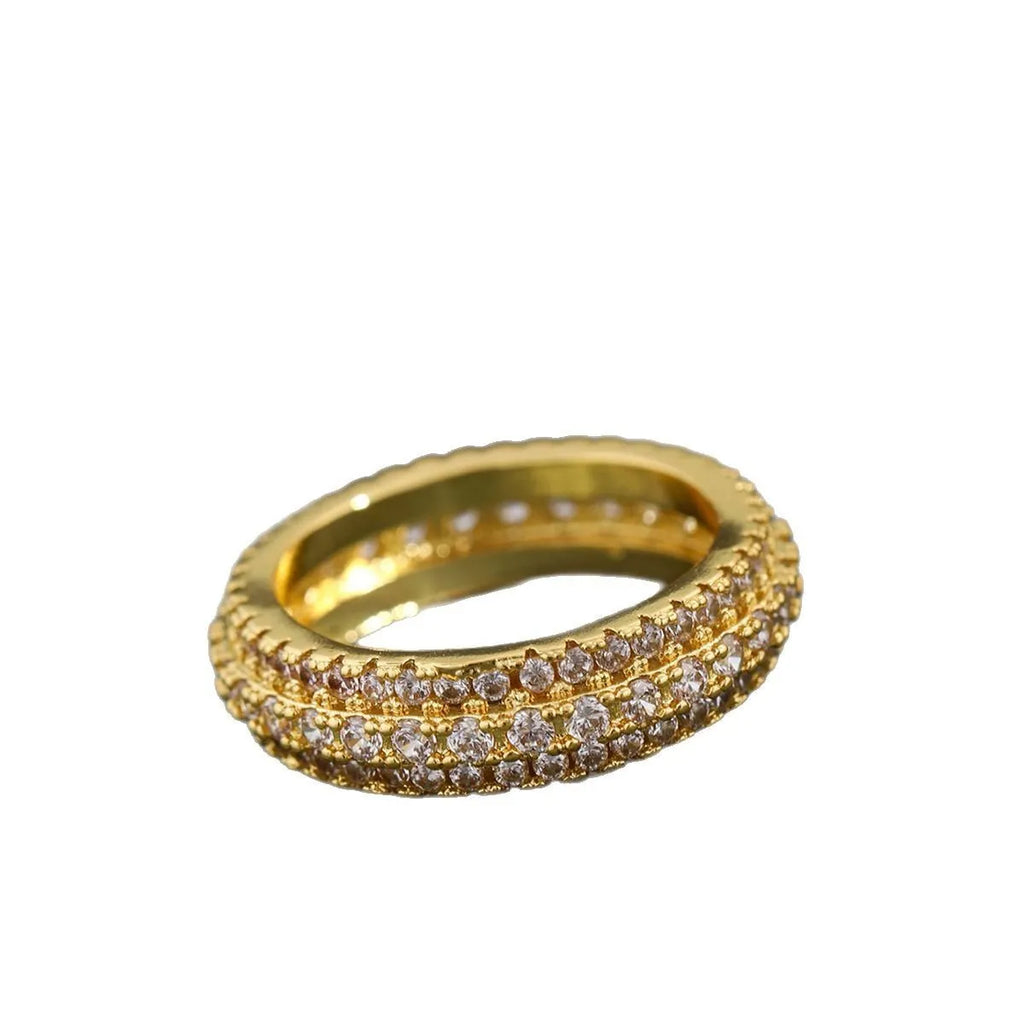 Geometric triangle engagement ring with zircon stone in yellow gold finish on a copper band.