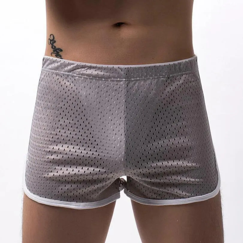 Men's solid colour boxer shorts in a cotton and nylon fabric blend, shown in black, on a mid-waist fit model.