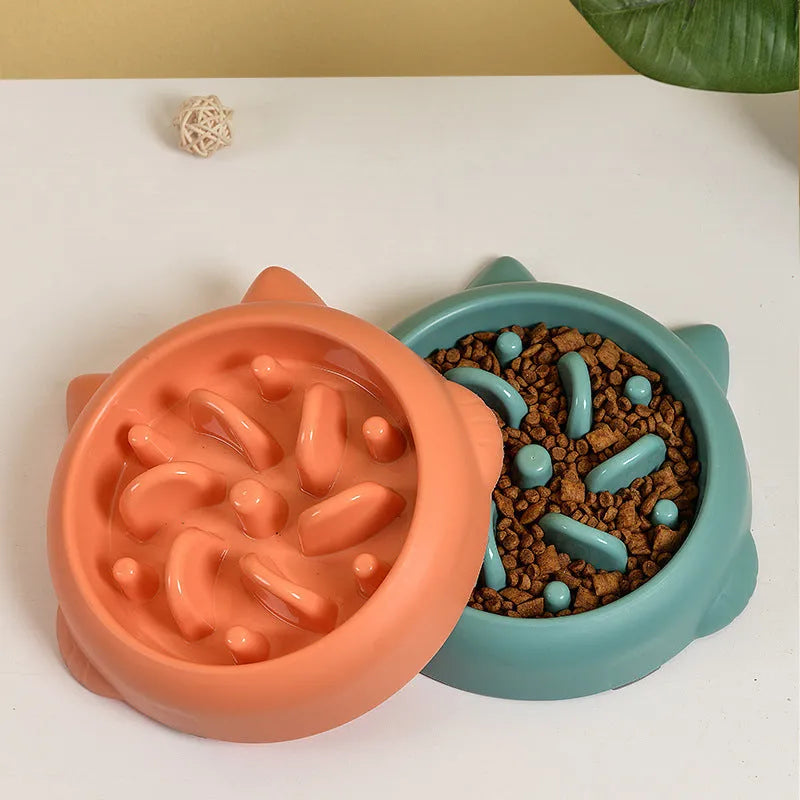 Green pet slow feeder bowl with raised bone-shaped obstacles inside to slow down eating.