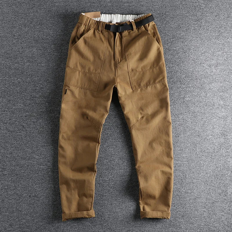 Men's khaki cotton work trousers showing N I buckle belt and three-dimensional cutting detail