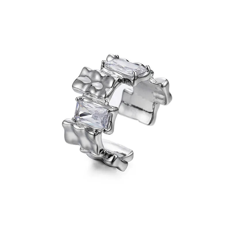 Silver geometric open ring with cross design and zircon decoration on white background