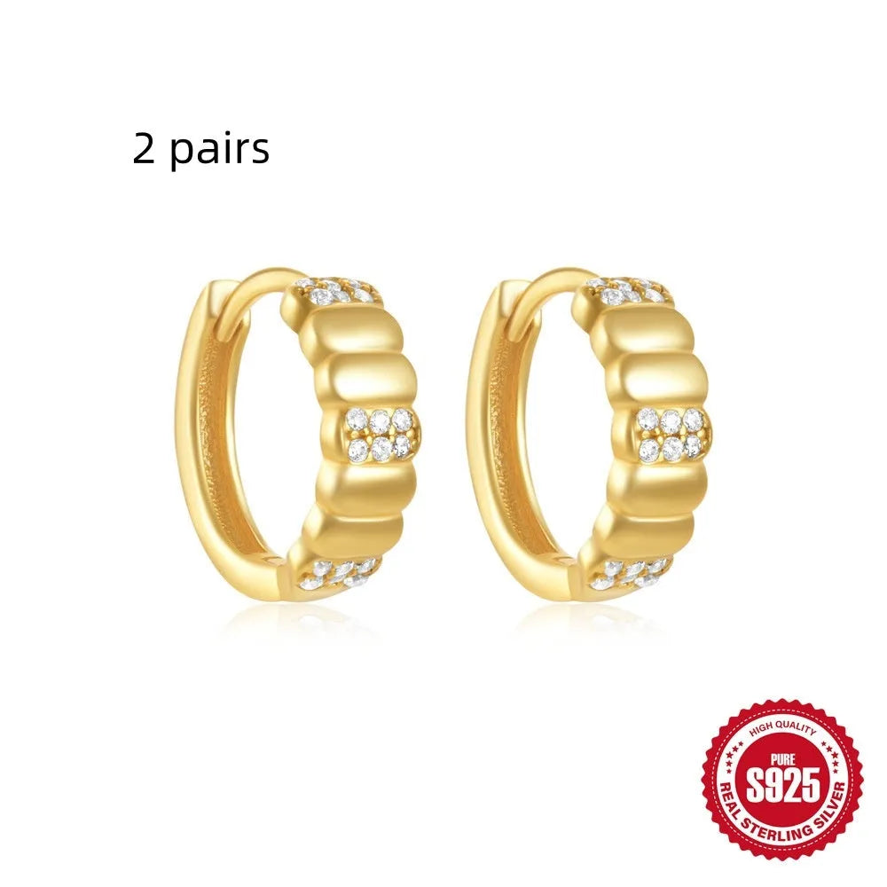 Small round geometric sterling silver stud earrings in gold and silver electroplated finishes.