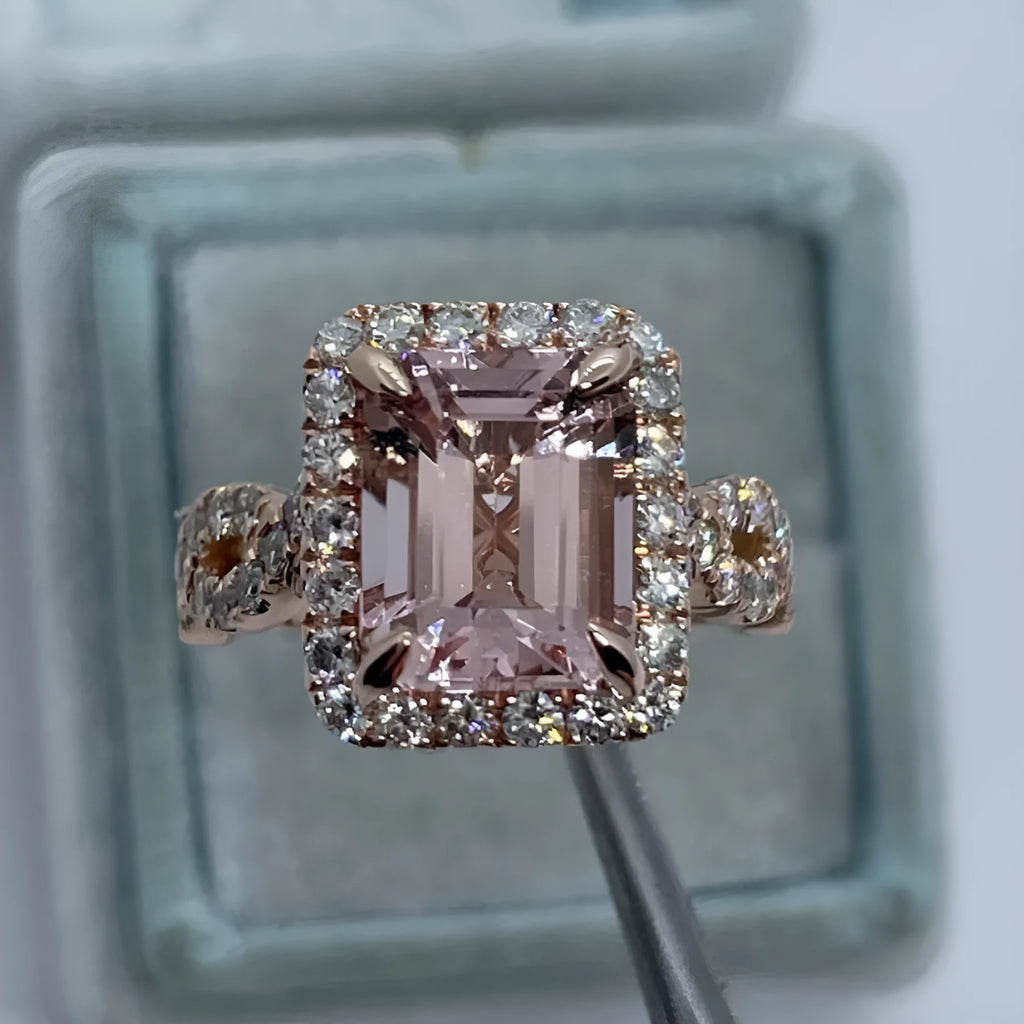 Rose gold geometric alloy ring on a plain background
