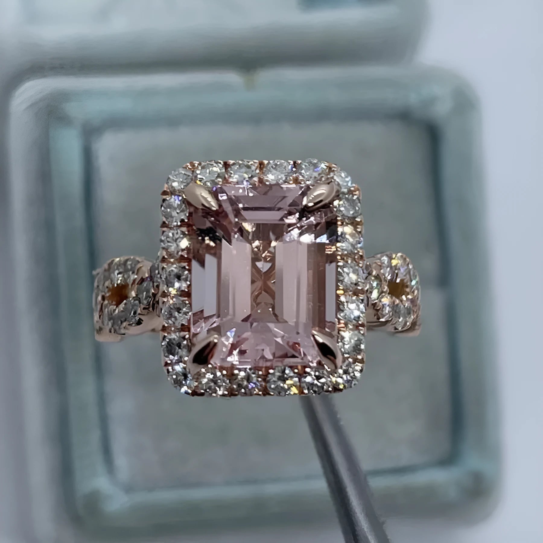 Rose gold geometric alloy ring on a plain background