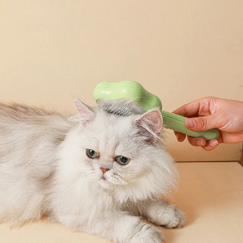 Large green self-cleaning cat comb magic wand with stainless steel needle teeth for pet grooming.