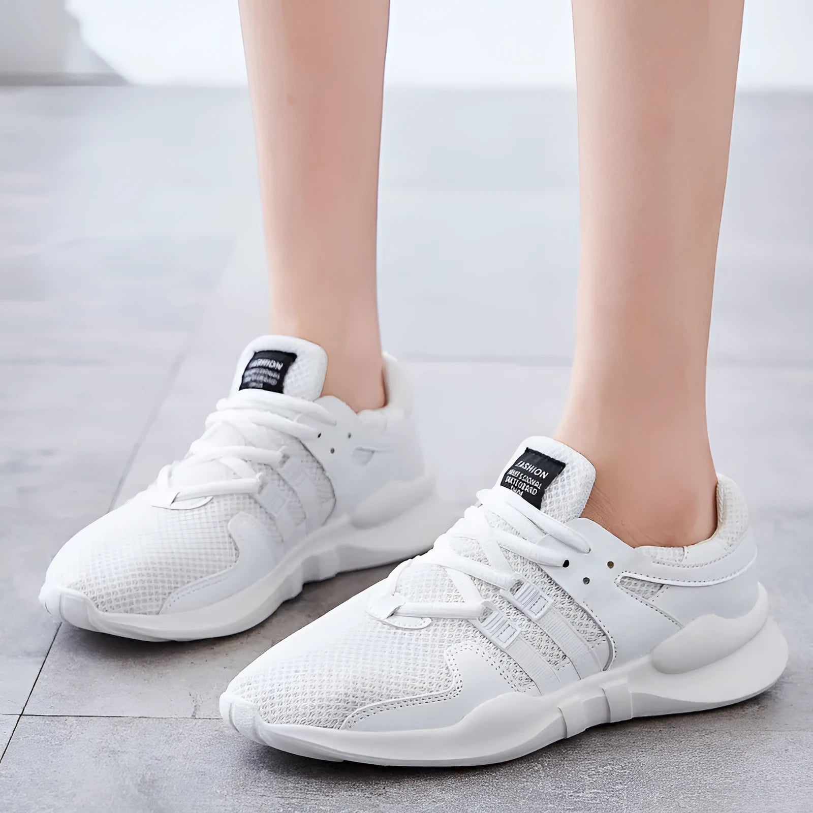 Men's low-top casual sneakers with hollow white mesh upper and round toe on a flat EVA sole.