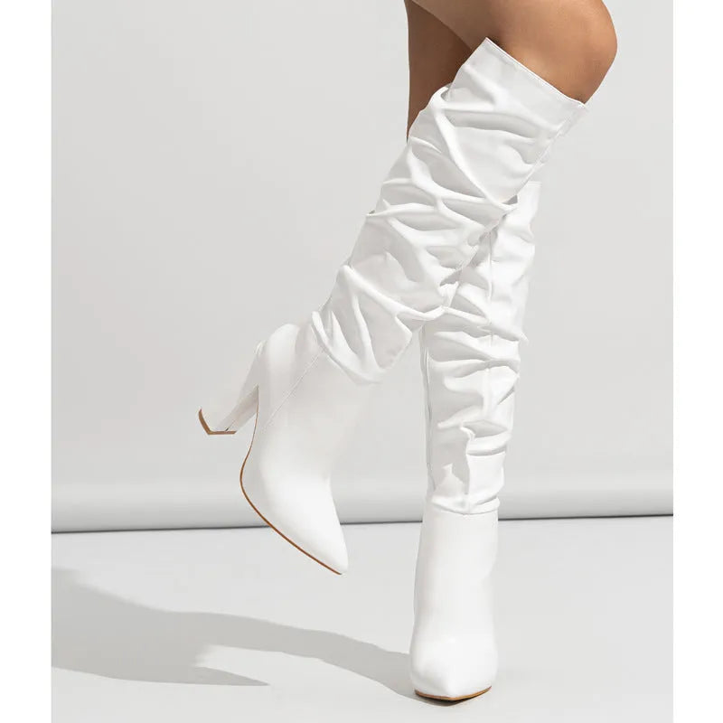 Women's long white pointed-toe high-heel boots with a side zipper, shown from the side.