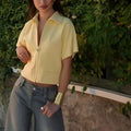 Casual polyester outerwear top in loose fit with short sleeves available in black, white or yellow colours