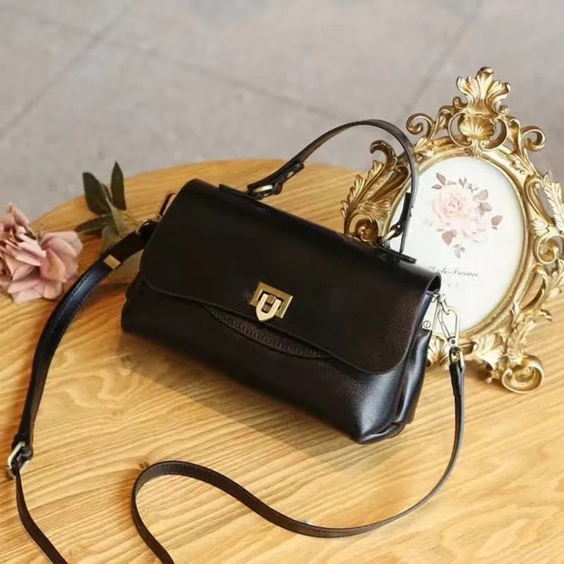 Women's dark brown genuine leather saddle back handbag with multiple compartments and shoulder straps