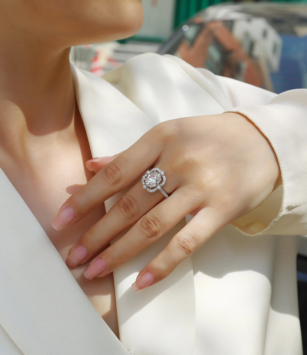 Camellia egg-shaped moissanite wedding ring set with S925 silver and platinum plating, showing centre stone and band