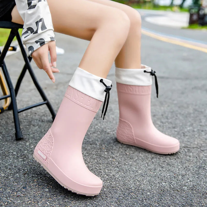 Women's solid colour PVC rain boots with non-slip soles in apricot, black, brown, and pink waterproof mouth options