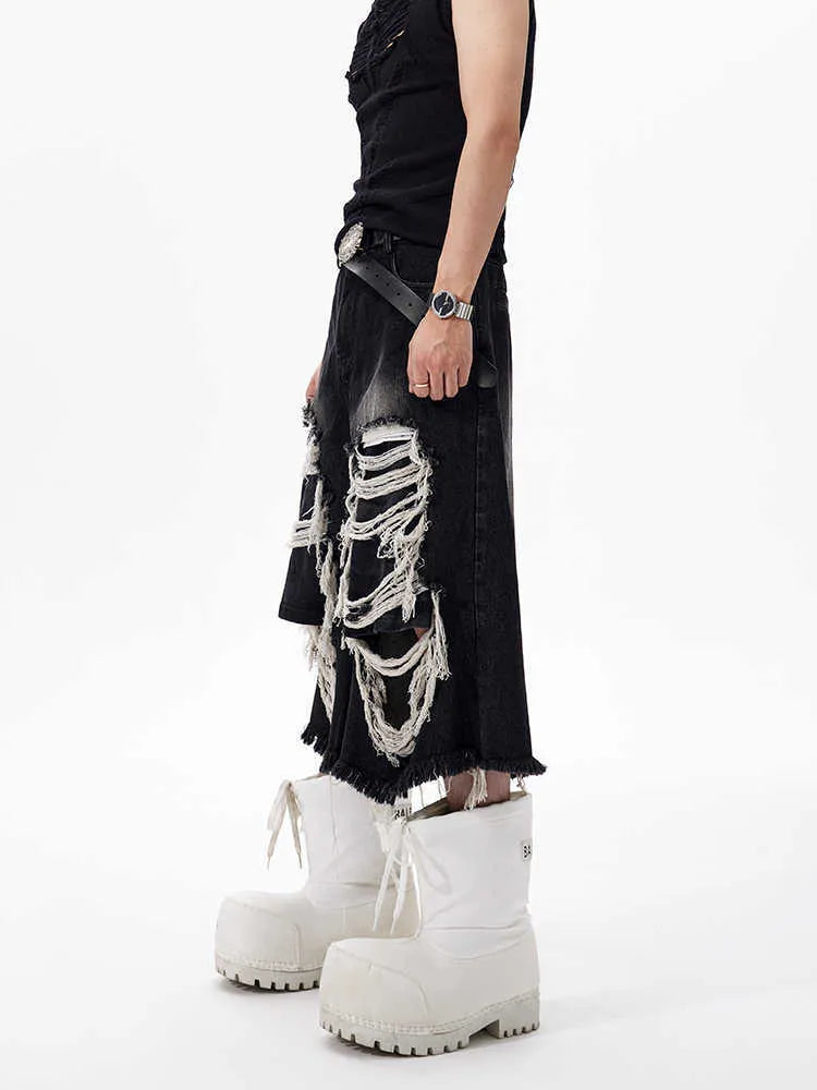 Black women's cropped wide leg jeans with distressed patches and a mid-high waist.