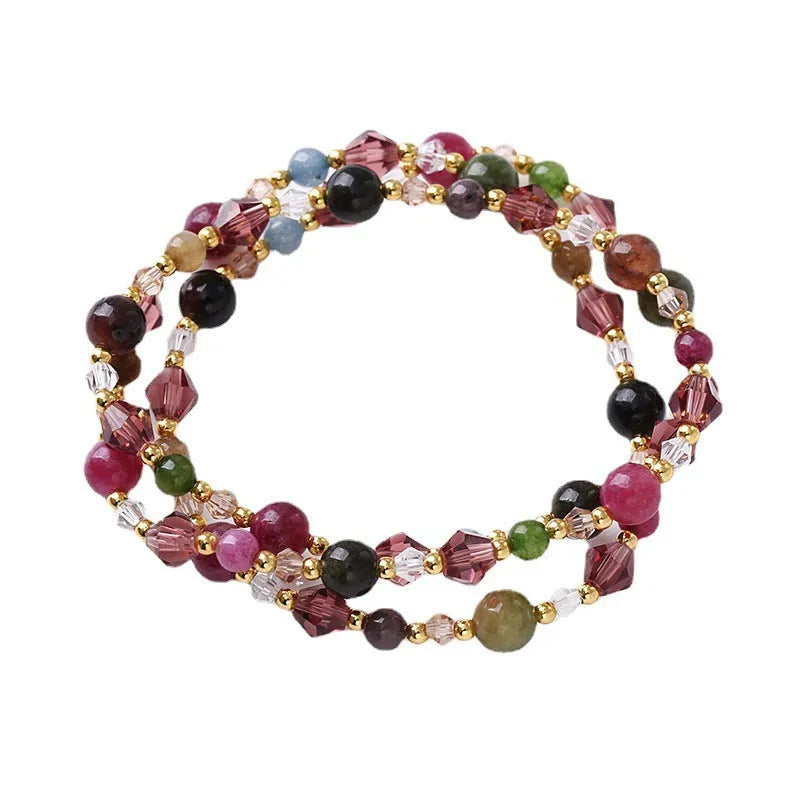 Women's adjustable three-ring bracelet with colourful tourmaline, strawberry quartz, and amethyst crystals on a cord.