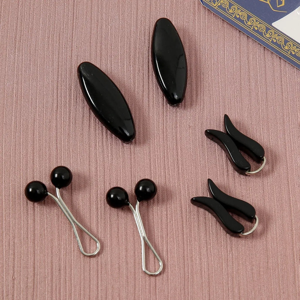 Plastic scarf clip with oval meander pattern and resin drip finish in five colours including black, gray, white, brown, and pink.