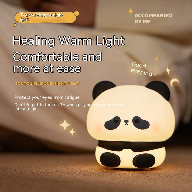 Panda LED night light with soft silicone head, USB rechargeable, touch control, colourful lights, on a bedside table