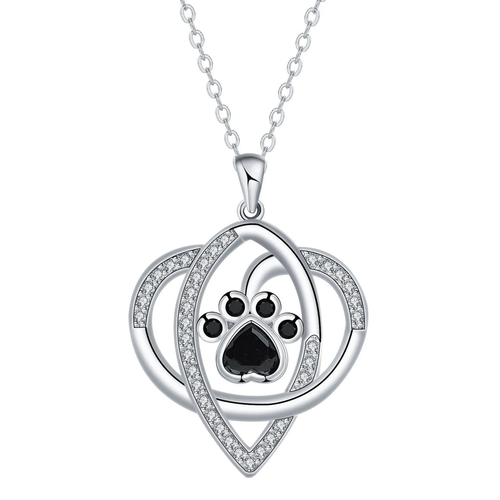 Close-up of a women's copper necklace with a dog paw print pendant on a cross chain.