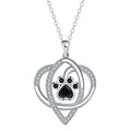 Close-up of a women's copper necklace with a dog paw print pendant on a cross chain.