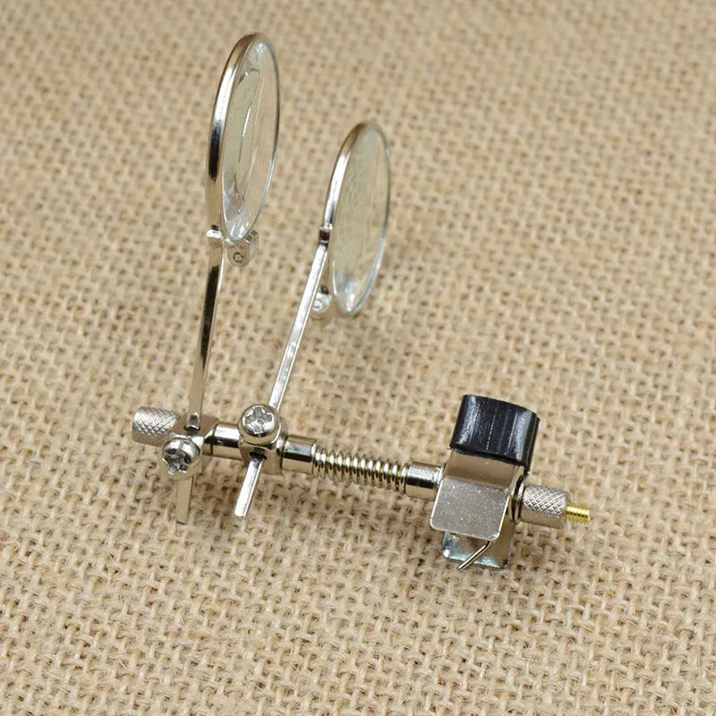 Auxiliary reading glasses magnifier with metal double clip and glass lens.